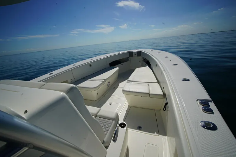 Slide: The Image of 2018 SeaVee 390Z boat interior with seating, on calm ocean waters under clear sky. - 14