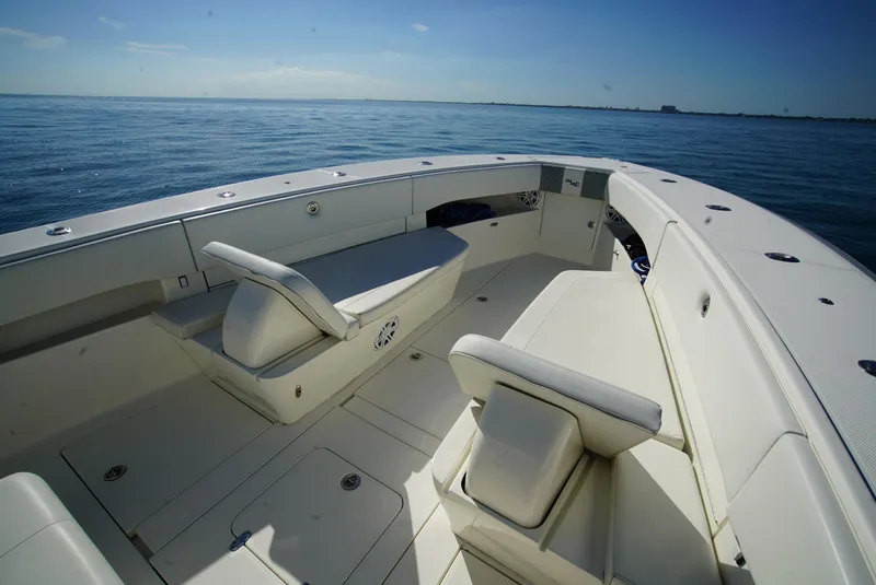 Slide: The Image of 2018 SeaVee 390Z boat interior with seating, on calm ocean waters. - 19