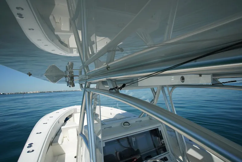 Slide: The Image of 2018 SeaVee 390Z boat, sleek design, open water, clear sky, modern navigation equipment. - 23