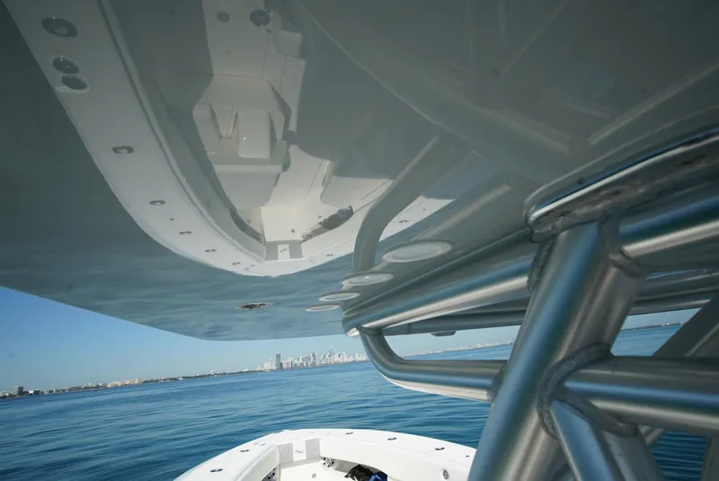 Slide: The Image of 2018 SeaVee 390Z boat with metal framework, ocean view, and distant city skyline. - 24