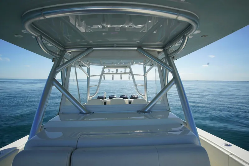 Slide: The Image of 2018 SeaVee 390Z boat on calm ocean, showcasing sleek design and sturdy structure. - 25