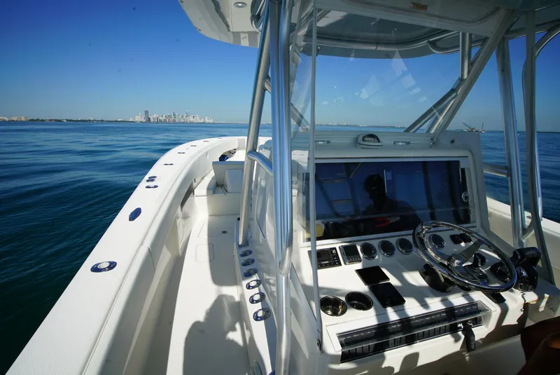 Slide: The Image of 2018 SeaVee 390Z boat interior with steering console, navigating calm waters. - 31