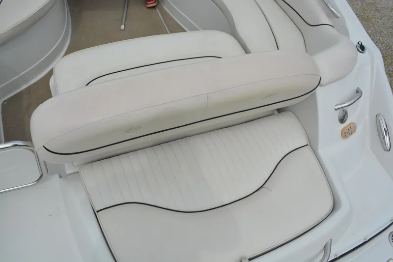 Slide: The Image of 2007 Crownline 275 CCR boat interior seating with white upholstery and black trim. - 11
