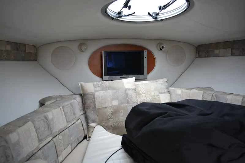 Slide: The Image of Interior of 2007 Crownline 275 CCR boat with cozy seating and a mounted TV. - 19