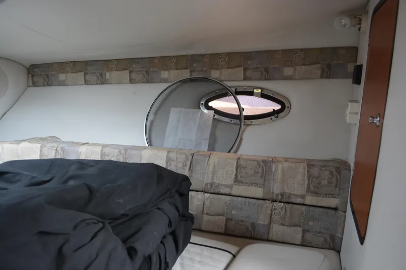 Slide: The Image of Interior cabin of 2007 Crownline 275 CCR boat with porthole and cushioned seating. - 20