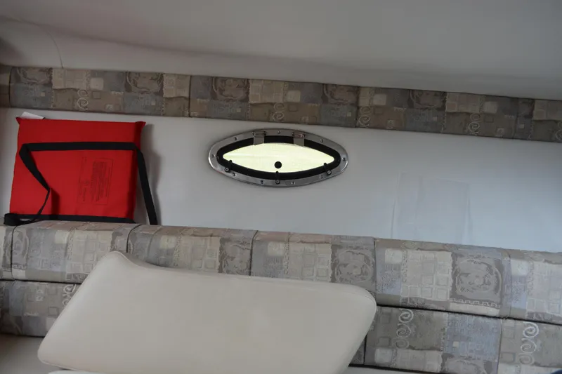 Slide: The Image of Interior of 2007 Crownline 275 CCR boat with patterned seating and oval window. - 21