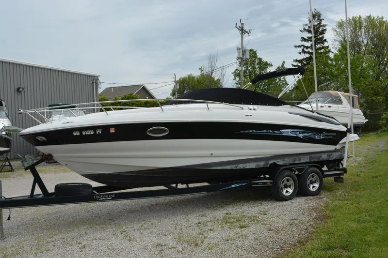 Slide: The Image of 2007 Crownline 275 CCR boat on trailer, parked outdoors near a building. - 4