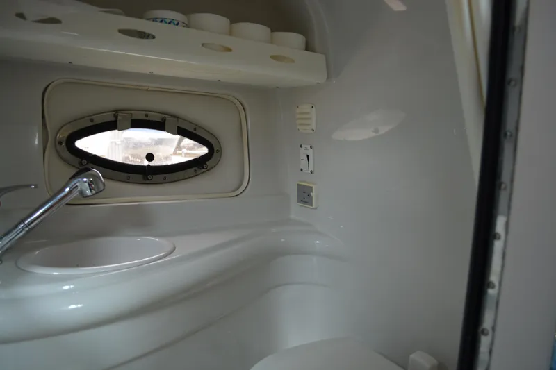 Slide: The Image of 2007 Crownline 275 CCR boat interior bathroom with sink and porthole window. - 8