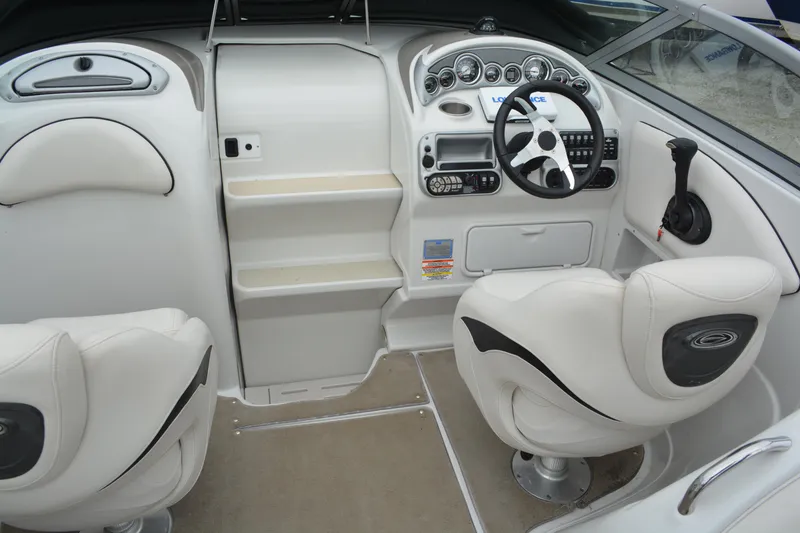 Slide: The Image of Interior of a 2007 Crownline 275 CCR boat with white seating and control panel. - 9