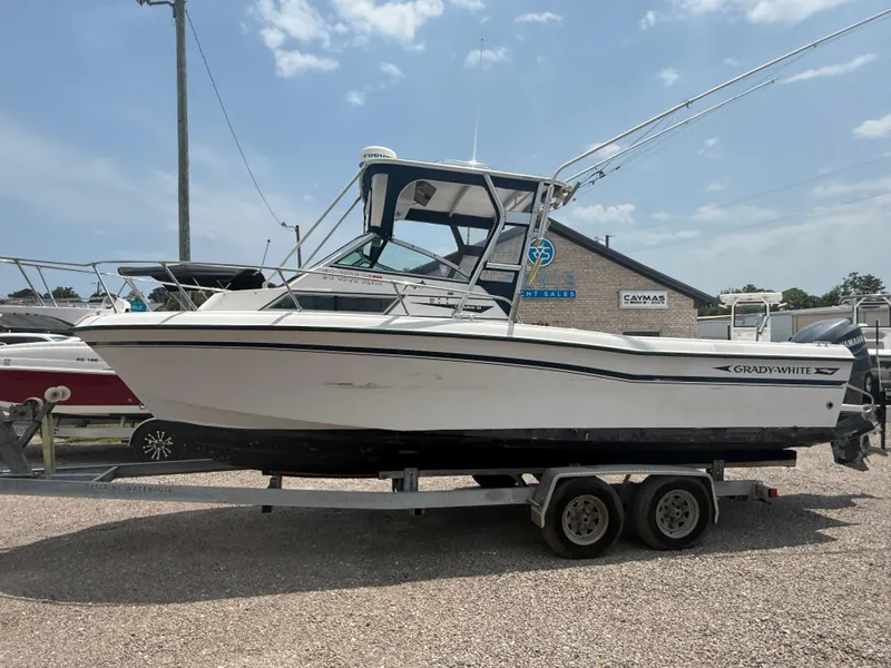 The Image of 1993 Grady-White Explorer 24 boat on trailer, parked outdoors under clear sky. - 1