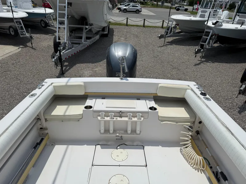 Slide: The Image of 1993 Grady-White Explorer 24 boat interior with seating and motor, displayed outdoors. - 11