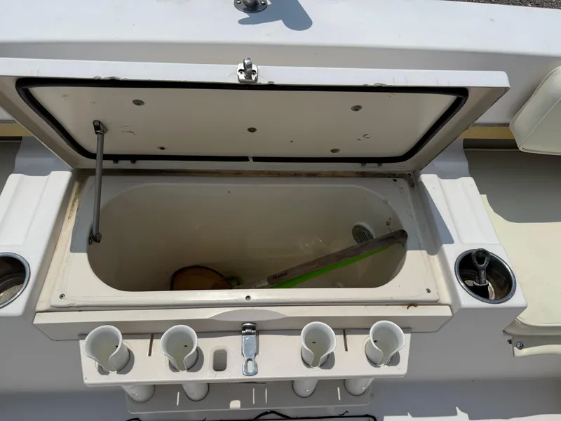 Slide: The Image of Open storage compartment on 1993 Grady-White Explorer 24 boat with fishing rod holders. - 14