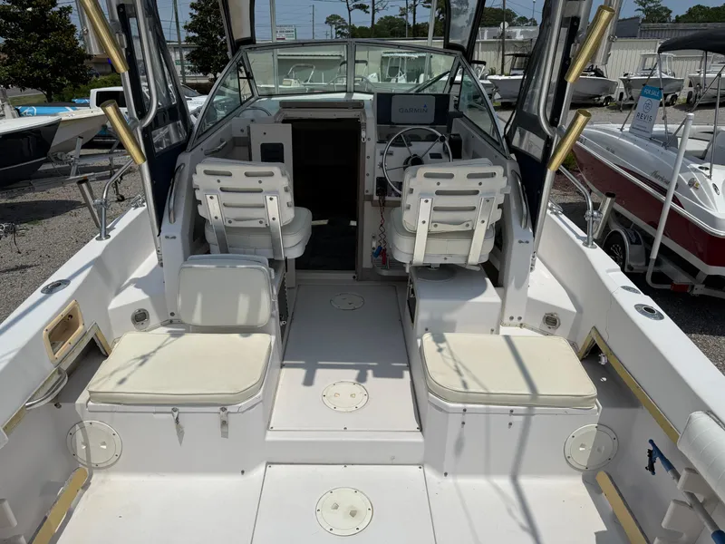 Slide: The Image of 1993 Grady-White Explorer 24 boat interior with seating and steering wheel. - 15