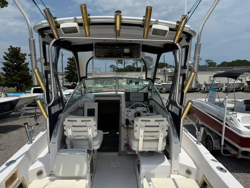 Slide: The Image of 1993 Grady-White Explorer 24 boat interior with dual seats and fishing rod holders. - 16