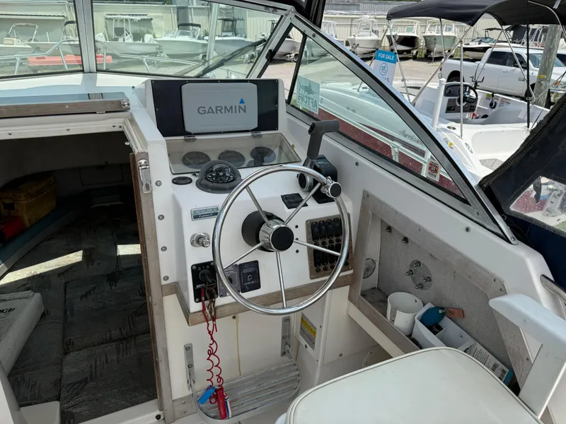 Slide: The Image of 1993 Grady-White Explorer 24 boat cockpit with Garmin navigation system and steering wheel. - 17