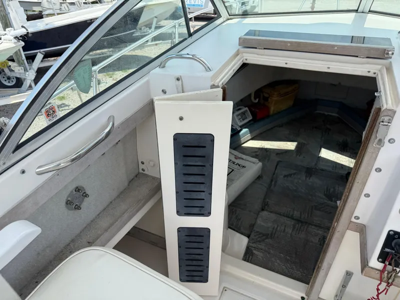 Slide: The Image of 1993 Grady-White Explorer 24 cabin interior with seating and storage. - 18