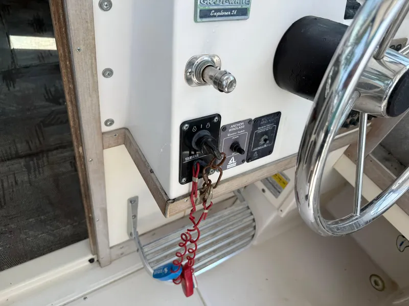 Slide: The Image of 1993 Grady-White Explorer 24 boat dashboard with steering wheel and ignition key. - 23
