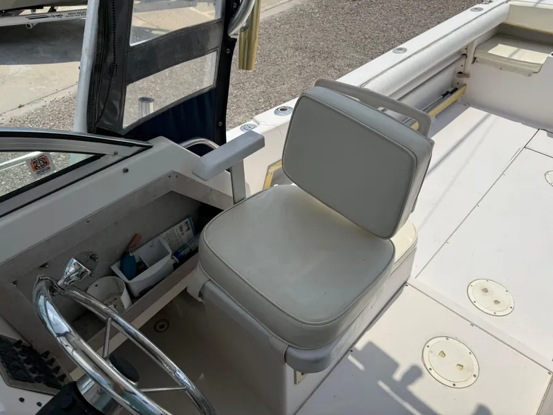 Slide: The Image of 1993 Grady-White Explorer 24 boat interior with steering wheel and cushioned seat. - 25