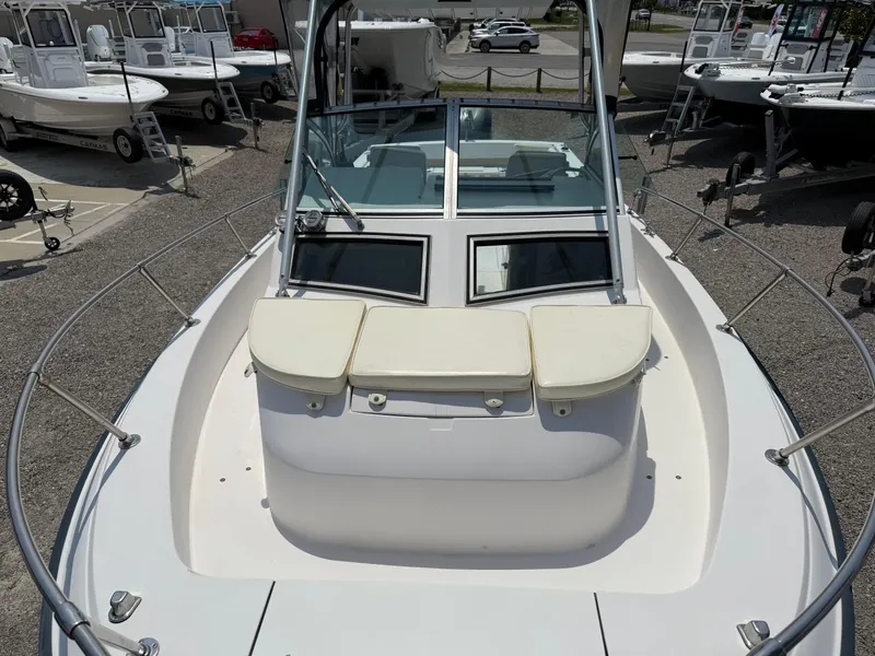 Slide: The Image of 1993 Grady-White Explorer 24 boat with cushioned seating and windshield, displayed outdoors. - 27