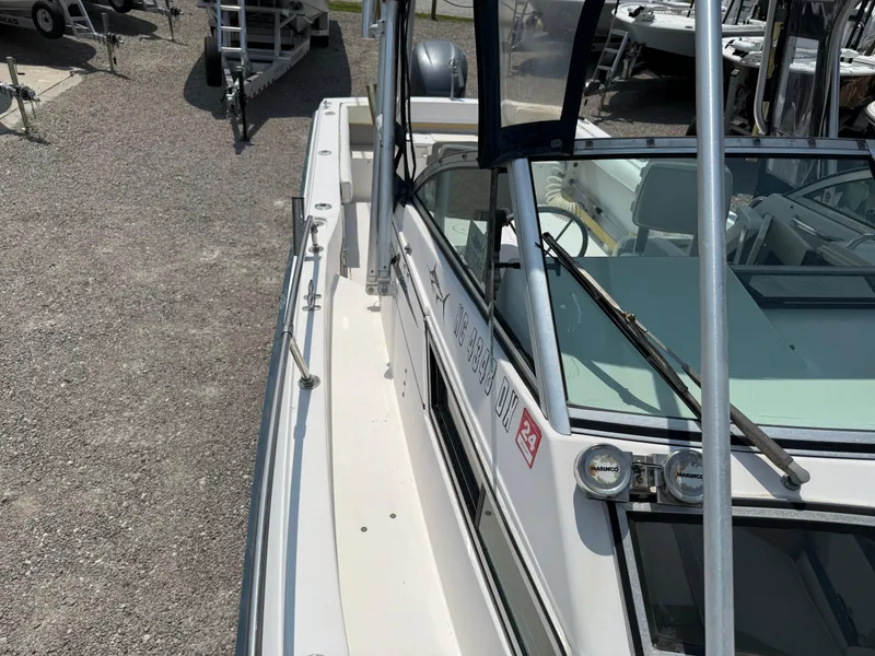 Slide: The Image of 1993 Grady-White Explorer 24 boat, side view, docked on gravel. - 31