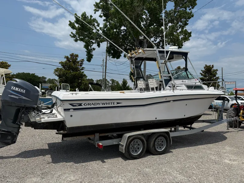 Slide: The Image of 1993 Grady-White Explorer 24 boat on trailer with Yamaha engine, parked outdoors. - 7