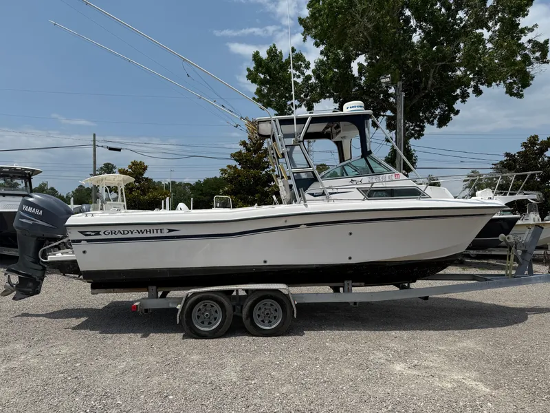 Slide: The Image of 1993 Grady-White Explorer 24 boat on trailer, parked outdoors. - 8