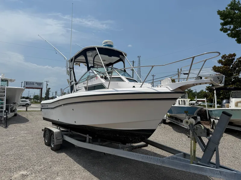 Slide: The Image of 1993 Grady-White Explorer 24 boat on trailer, parked outdoors under a clear sky. - 9