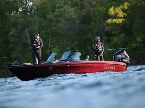 Slide: The Image of 2026 Lund 219 Pro V GL boat with two anglers fishing on a lake. - 1