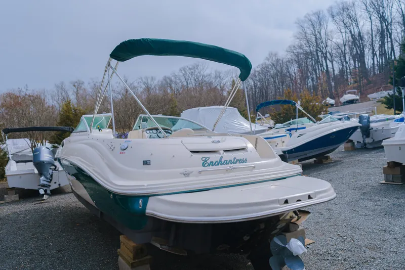 Slide: The Image of 2003 Sea Ray 240 Sundeck boat on display in a marina. - 4