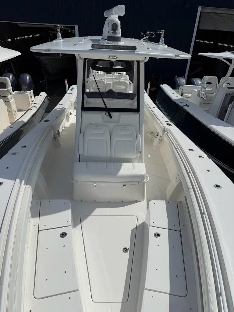 Slide: The Image of 2021 Regulator 31 boat with sleek design and spacious deck in marina setting. - 10