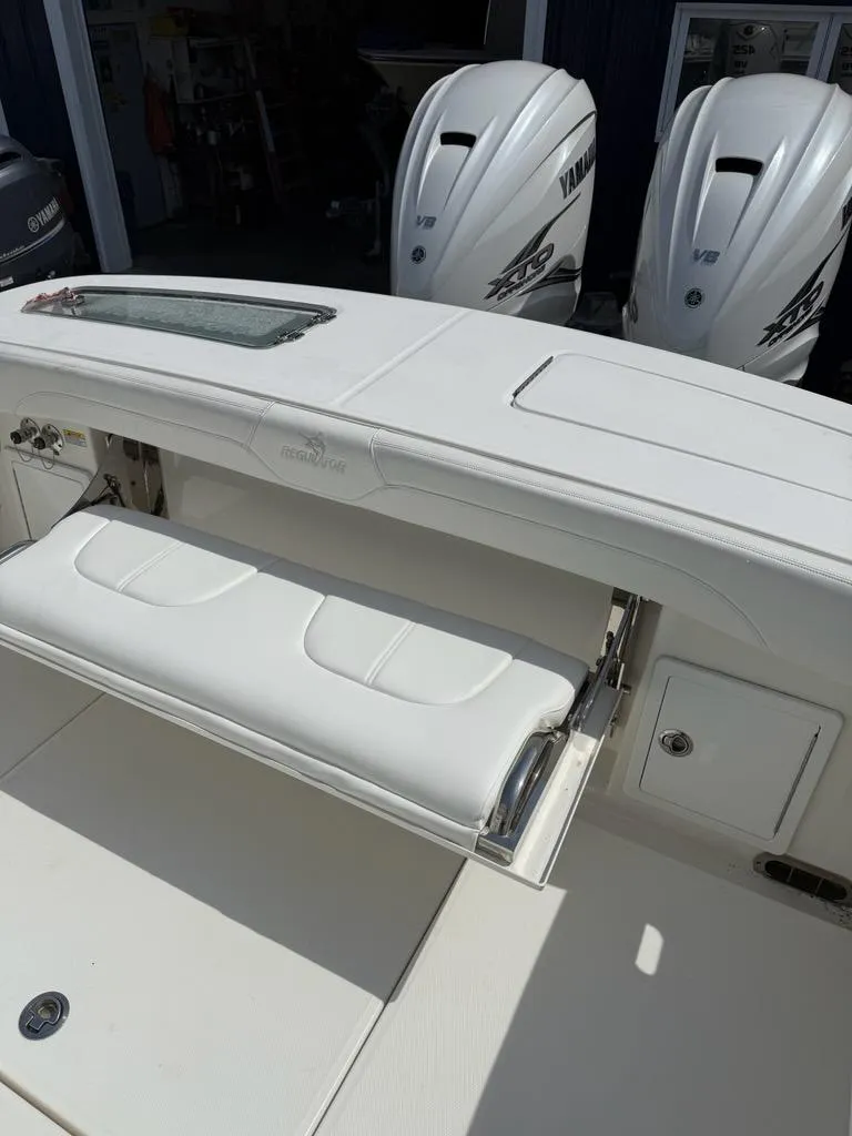 Slide: The Image of 2021 Regulator 31 boat with dual Yamaha outboard engines and white seating. - 11