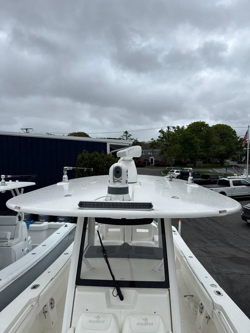 Slide: The Image of 2021 Regulator 31 boat with radar, parked under cloudy skies. - 15