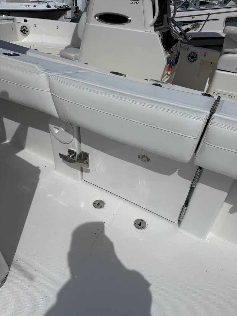 Slide: The Image of 2021 Regulator 31 boat interior with white seating and storage compartments. - 16