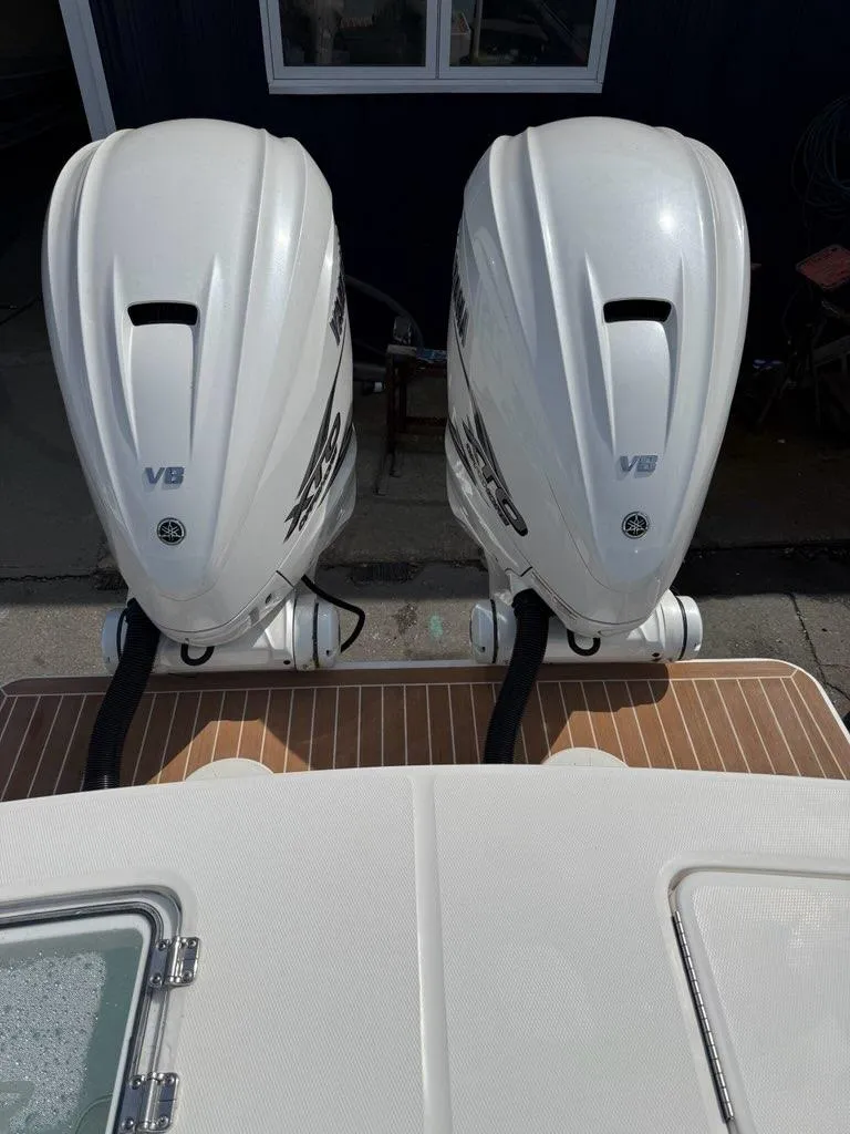 Slide: The Image of Twin V8 outboard engines on a 2021 Regulator 31 boat, docked. - 17