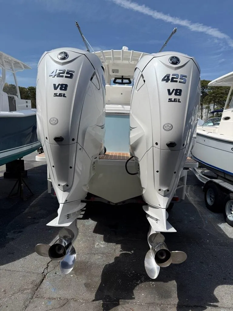 Slide: The Image of 2021 Regulator 31 boat with twin 425 V8 engines, docked outdoors. - 18