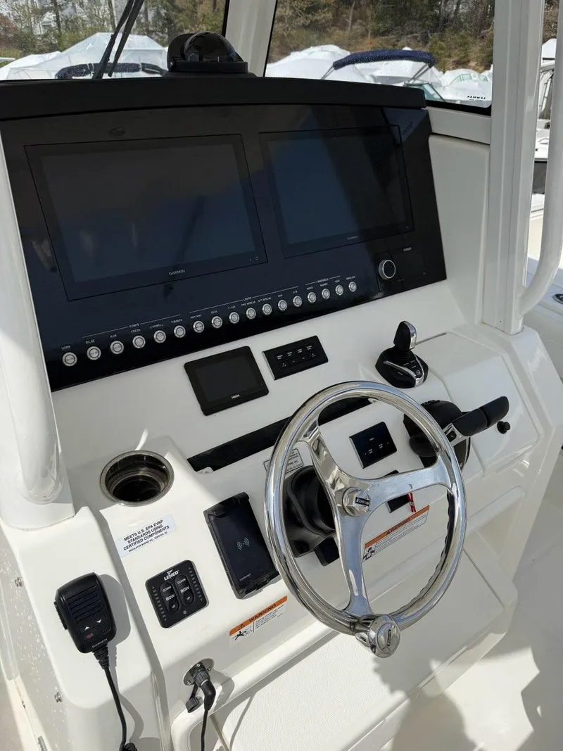 Slide: The Image of 2021 Regulator 31 boat dashboard with steering wheel and electronic controls. - 3