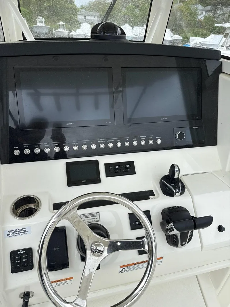 Slide: The Image of 2021 Regulator 31 boat dashboard with dual screens and steering wheel. - 4