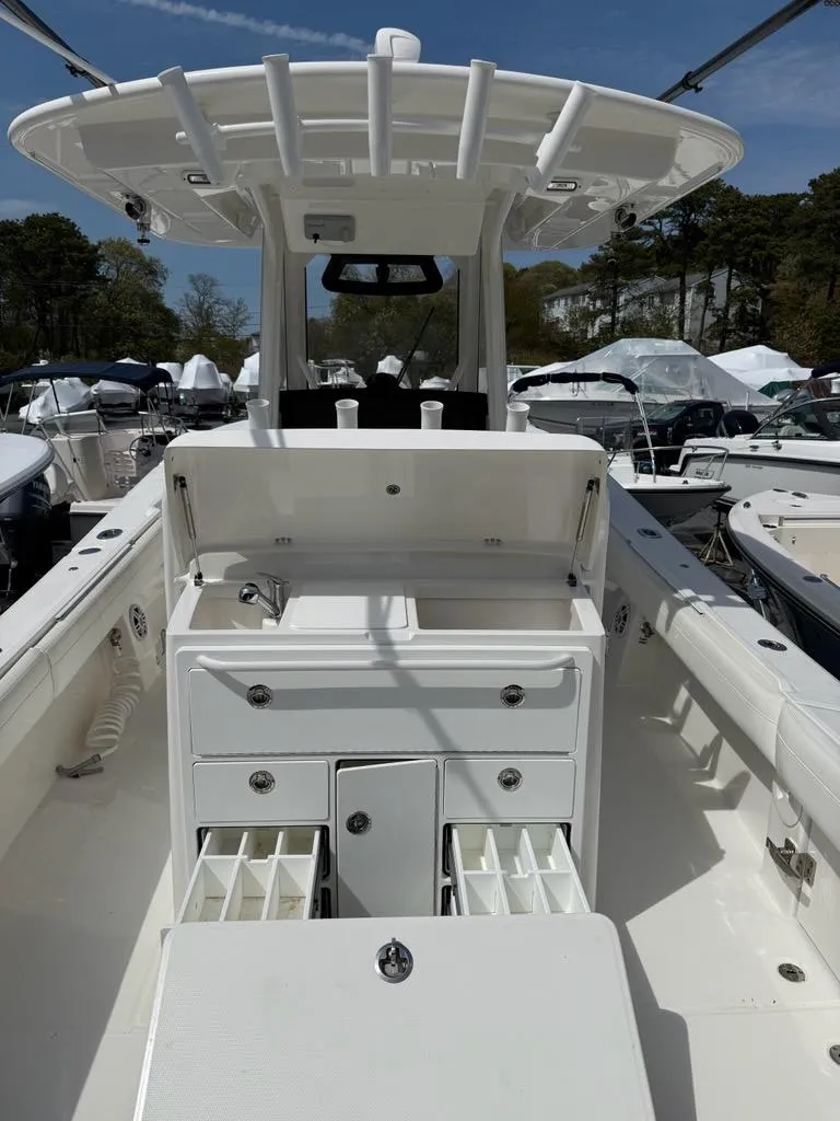 Slide: The Image of 2021 Regulator 31 boat interior with storage compartments and fishing rod holders. - 6