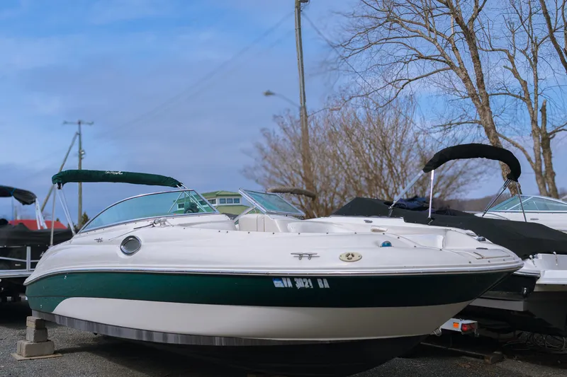Slide: The Image of 2003 Sea Ray 240 Sundeck boat on display, featuring a sleek white and green design. - 0