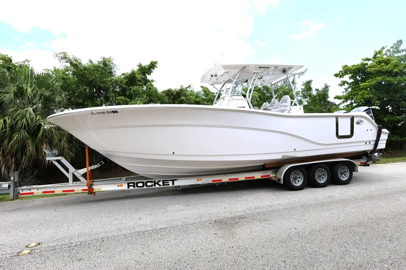 Slide: The Image of 2020 Sea Fox 328 Commander boat on a trailer, parked on a road. - 1