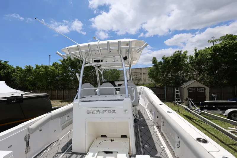 Slide: The Image of 2020 Sea Fox 328 Commander boat with T-top, docked outdoors under blue sky. - 10