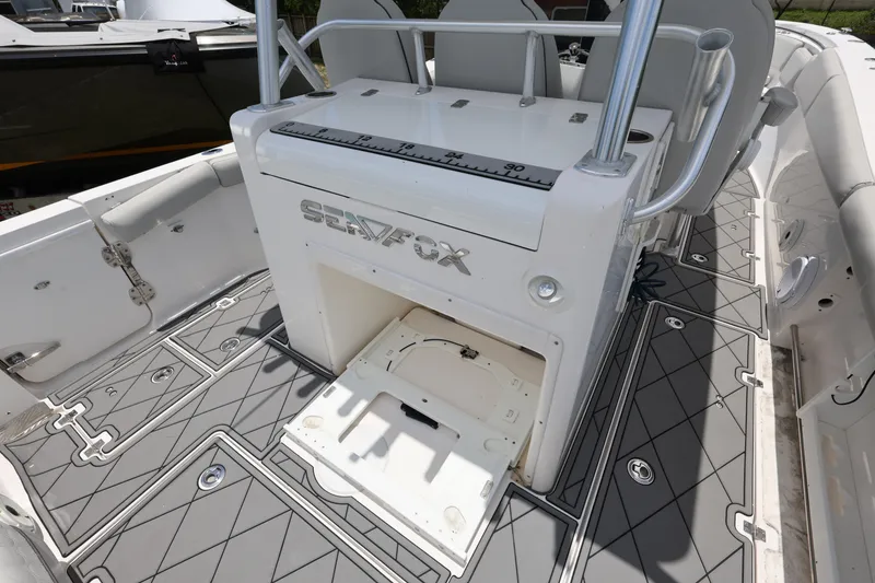 Slide: The Image of 2020 Sea Fox 328 Commander boat deck with storage compartment and sleek design. - 12