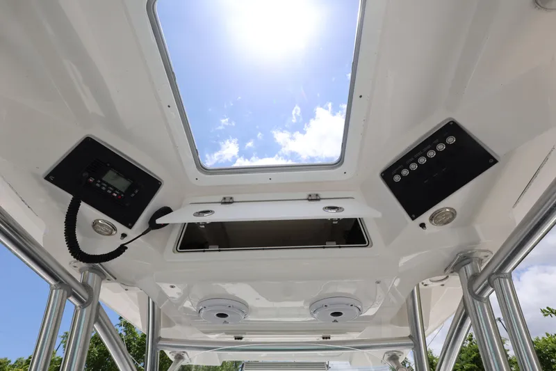 Slide: The Image of Interior view of 2020 Sea Fox 328 Commander boat with open hatch and control panels. - 17