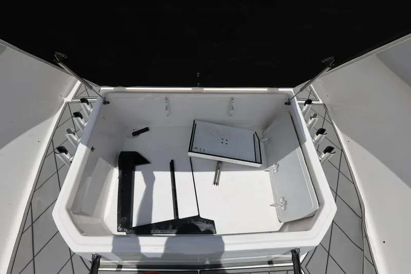 Slide: The Image of Open storage compartment on 2020 Sea Fox 328 Commander boat, showing interior space and accessories. - 24
