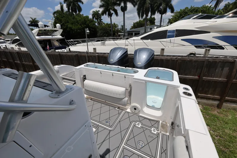 Slide: The Image of 2020 Sea Fox 328 Commander boat with dual engines, docked near luxury yachts. - 28