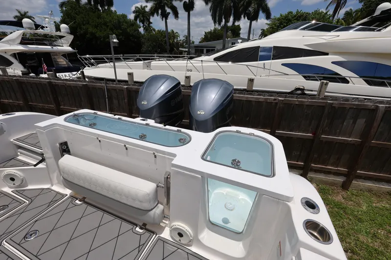 Slide: The Image of 2020 Sea Fox 328 Commander boat with dual Yamaha engines docked near luxury yachts. - 29