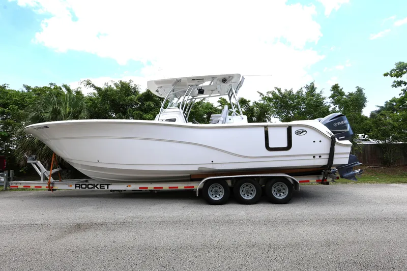 Slide: The Image of 2020 Sea Fox 328 Commander boat on trailer, parked on a road. - 3