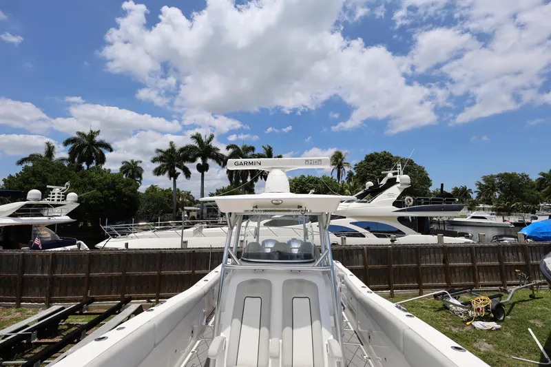 Slide: The Image of 2020 Sea Fox 328 Commander boat docked, surrounded by yachts, under a partly cloudy sky. - 31