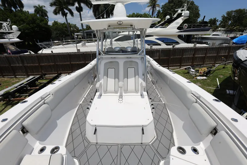 Slide: The Image of 2020 Sea Fox 328 Commander boat interior with seating and helm, docked outdoors. - 32
