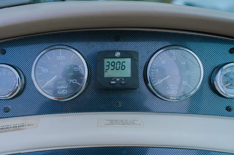 Slide: The Image of Dashboard of 2003 Sea Ray 240 Sundeck with gauges and digital display. - 8